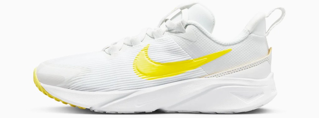 white and yellow nike running shoe