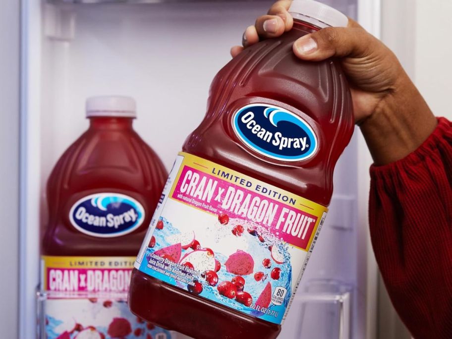 A person taking Ocen Spray Cran x Dragon Fruit out of a fridge 