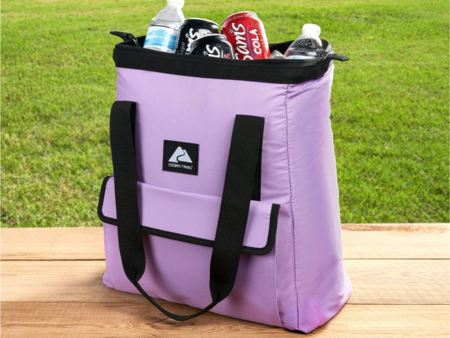 Ozark Trail 24 Can Wide Mouth Soft Cooler Tote in Purple on a picnic table 