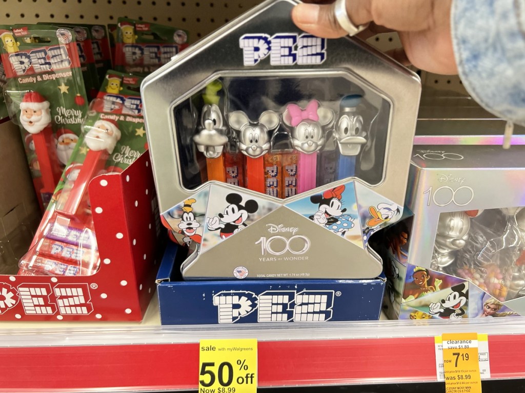 hand holding a PEZ Disney Candy Dispenser Set