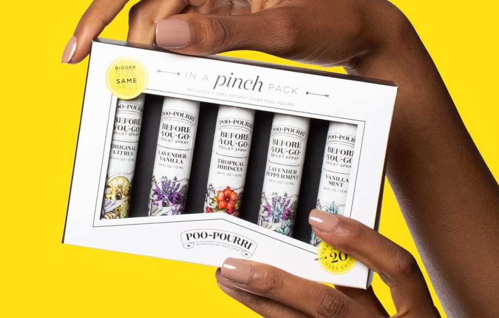 Hand holding the Poo Pourri In A Pinch pack