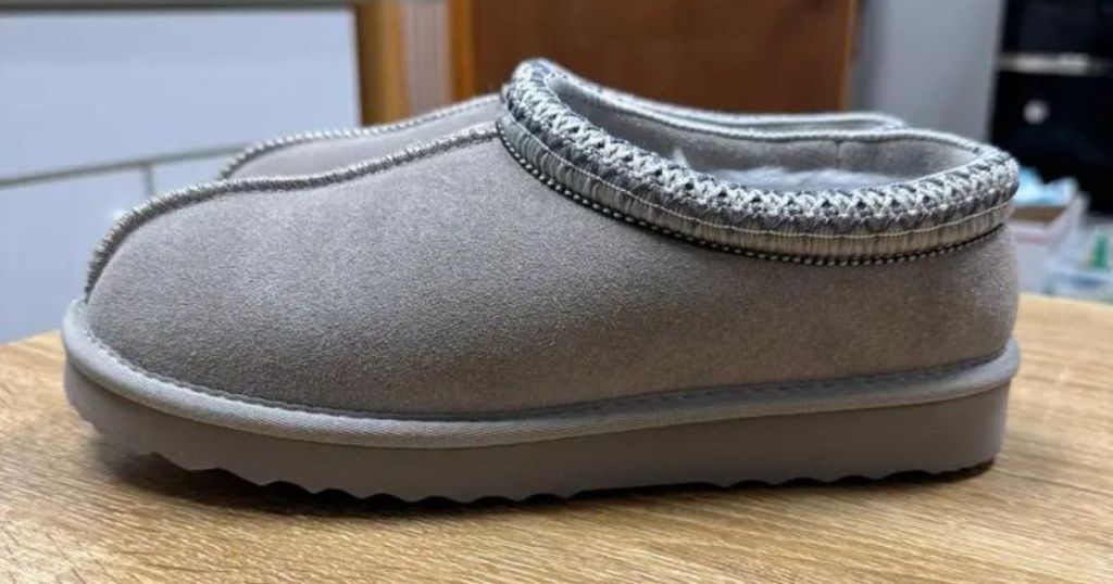 gray shearling clog slippers on counter