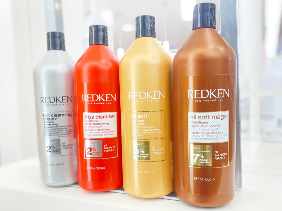 four liter bottles of Redken Shampoo & Conditioner