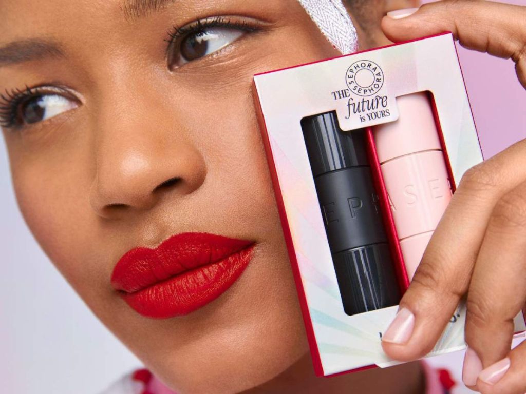 Woman holding a Sephora Collection Lipstick Gift Set next to her face