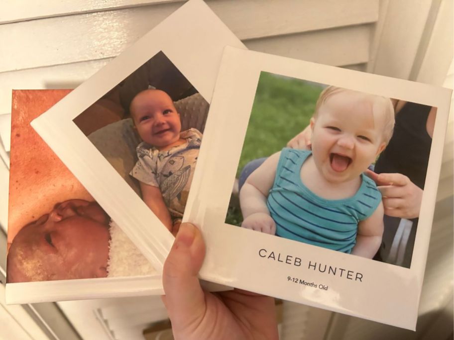 Hand holding 3 Shutterfly 6x6 instant photo books