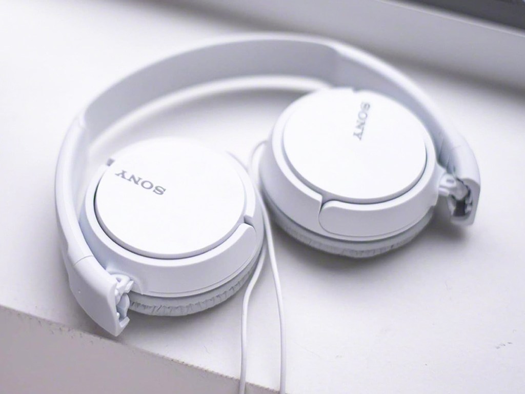 folded white sony headphones
