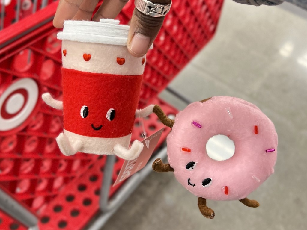 hand holding up a coffee and donut felt duo holding hands