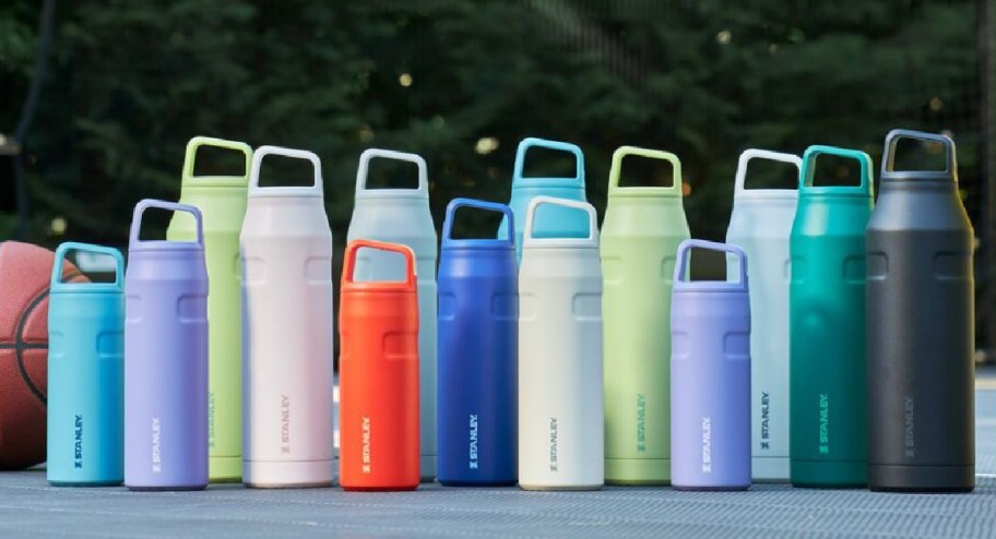 Stanley water bottles displayed in a basketball court