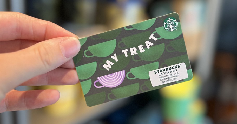 hand holding up a green Starbucks gift card