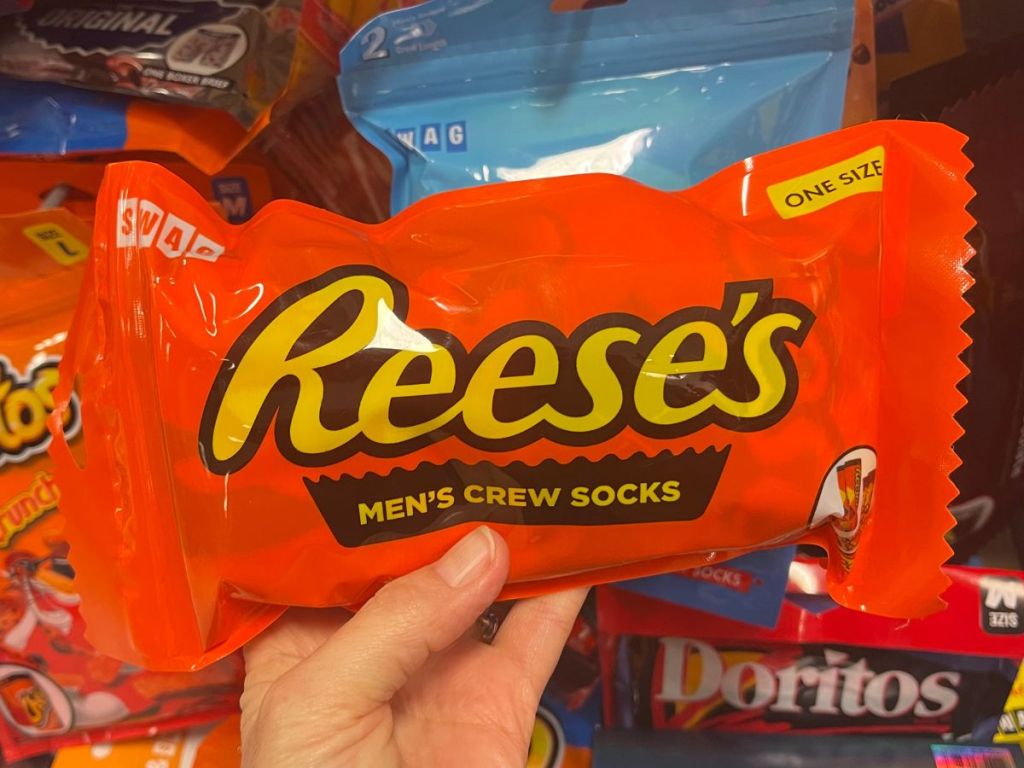 a womans hand displaying Swag reeses mens crew socks