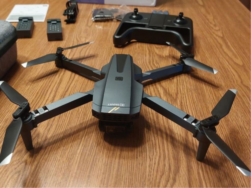 A Terasco Drone with remote control and batteries on a table