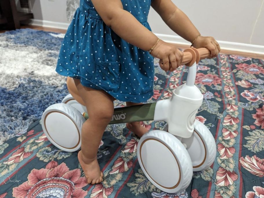 Little girl riding a balance bike