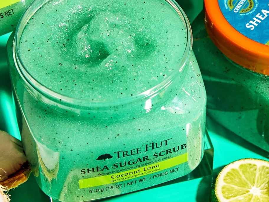 opened container of green sugar body scrub