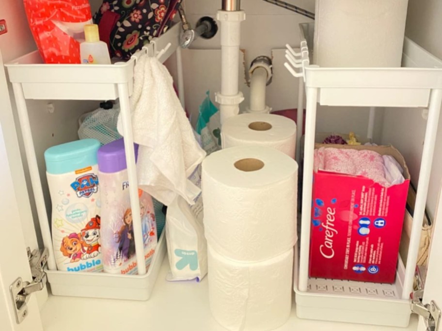 two under the sink organizers in white with bathroom supplies