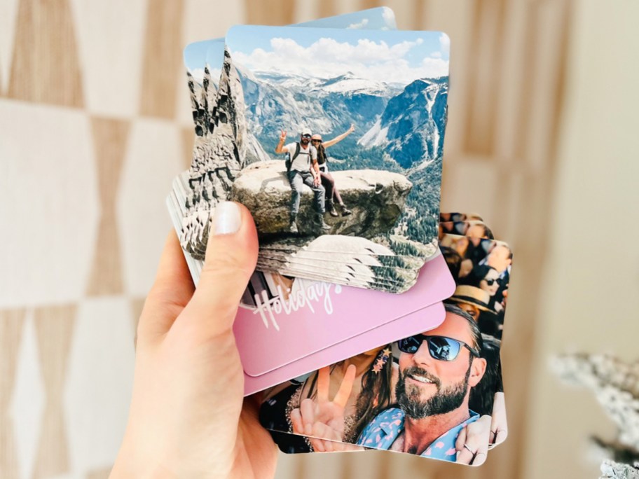 hand holding up a stack of photo coasters
