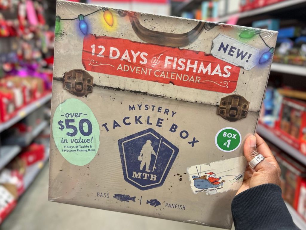Hand holding up a 12 Days of Fishmas fishing advent calendar