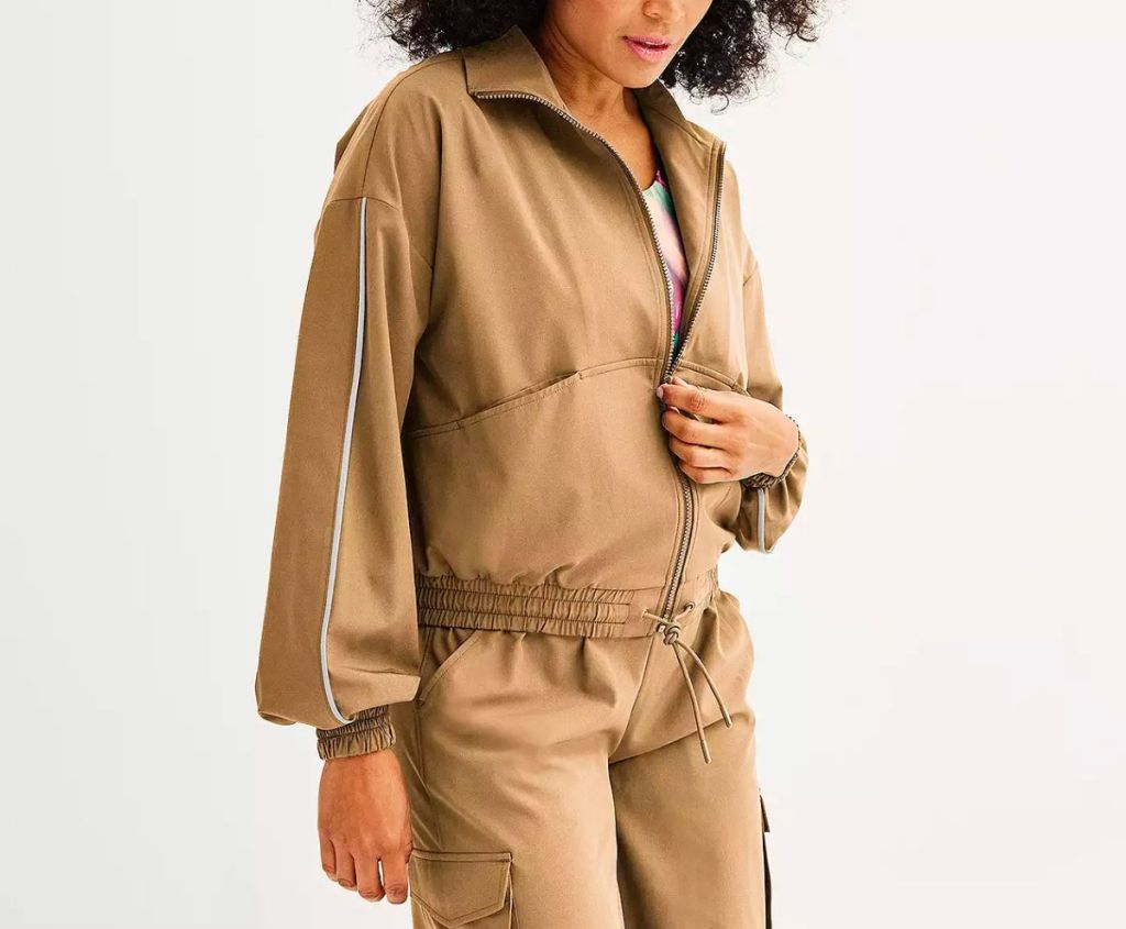 a model wearing a Women's Tek Gear Woven Windbreaker Jacket