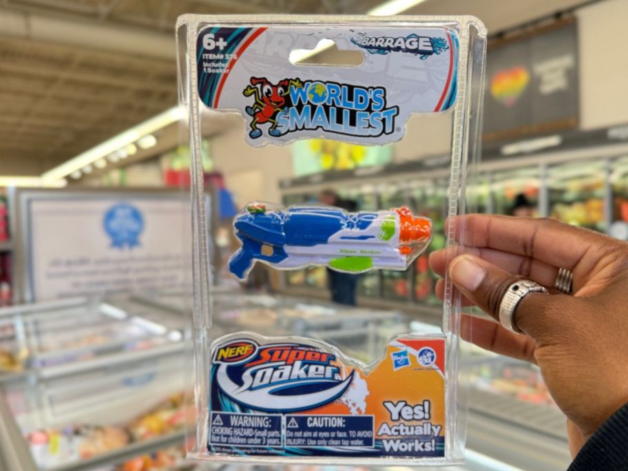 A hand holding The World's Smallest Super Soaker 