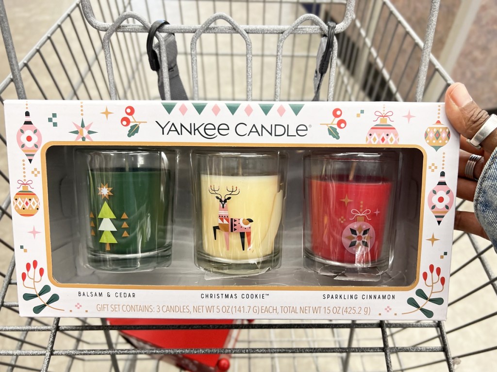 hand holding up a Yankee Candle Holiday Candle Set