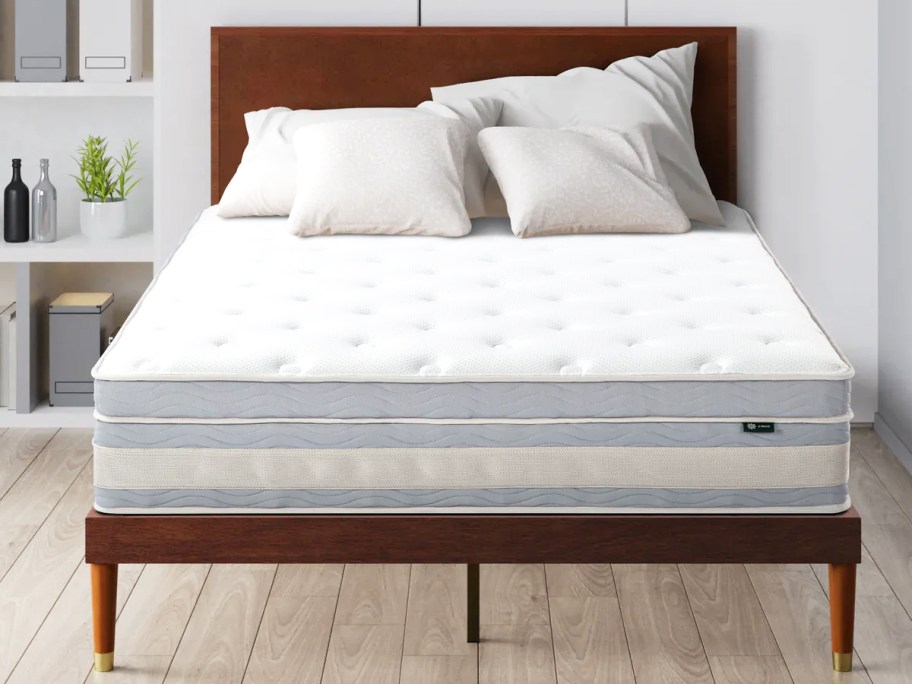 memory foam mattress on a wood bed frame with wood headboard