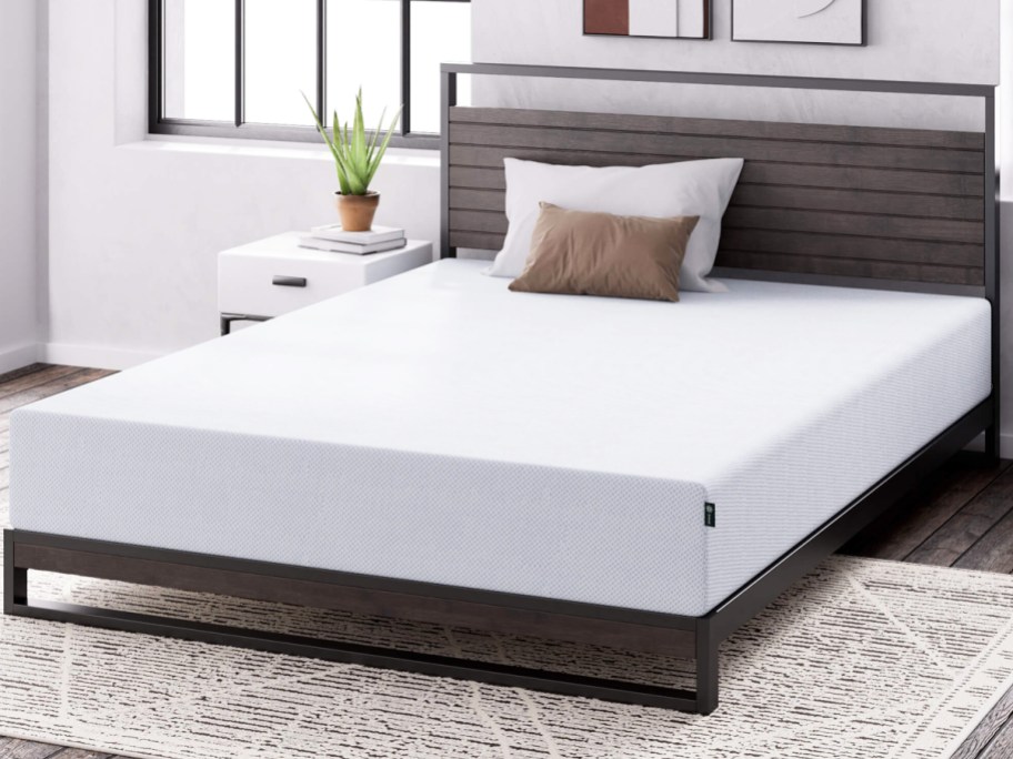 memory foam mattress on a metal bed frame with wood headboard
