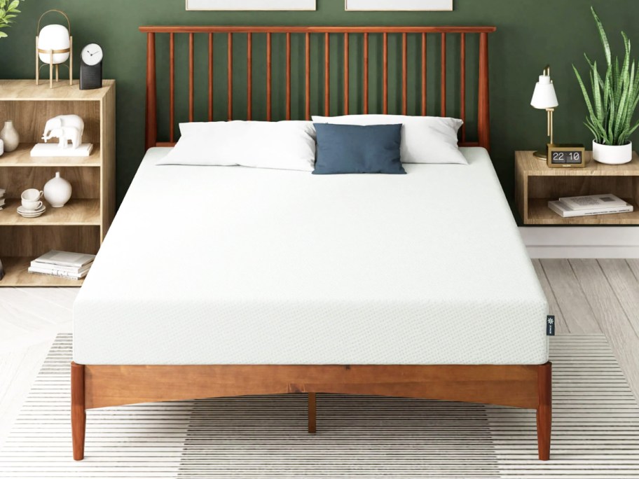 memory foam mattress on a wood bed frame with wood headboard