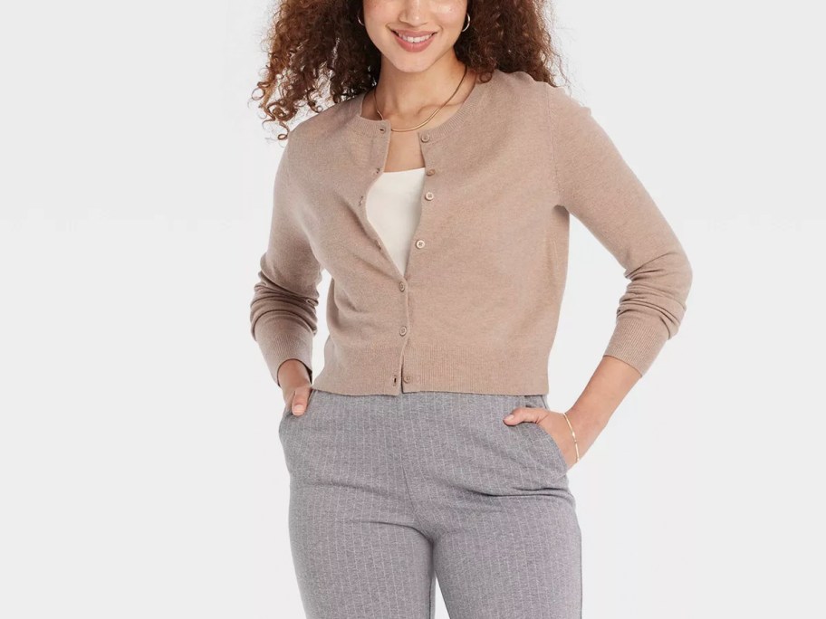 woman wearing tan sweater and gray pants 