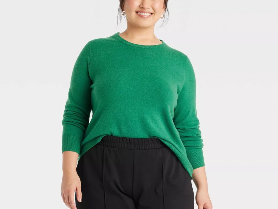 woman wearing green sweater and black pants 