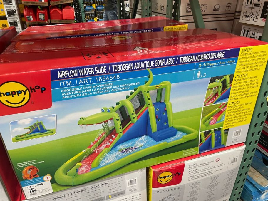 a big box with an image of an alligator themed inflatable kids water slide on the front