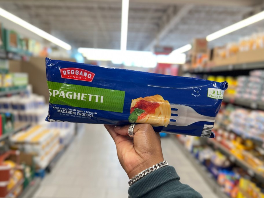 holding a bag of pasta