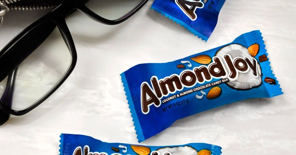 almond joy snack size bar on a marble counter next to a pair of glasses