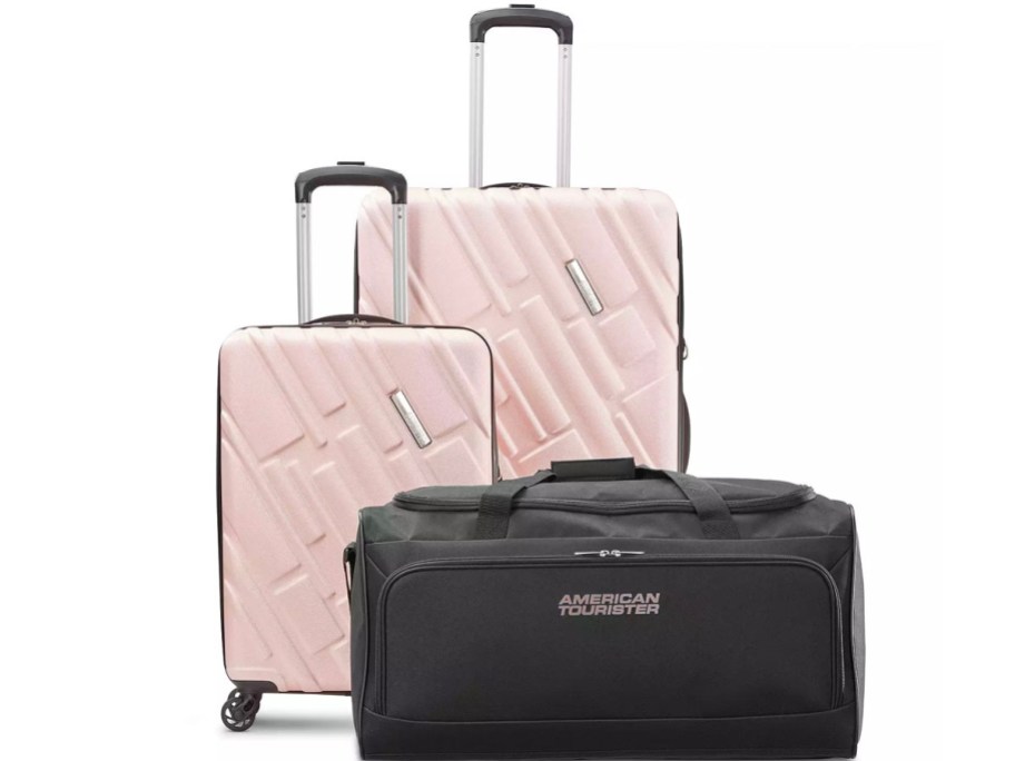 two pink hardside spinner luggage with black duffle stock image