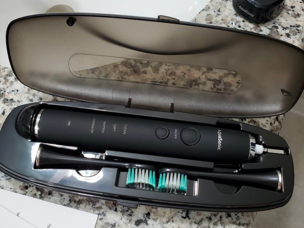 black aquasonic toothbrush in case with two extra brush heads