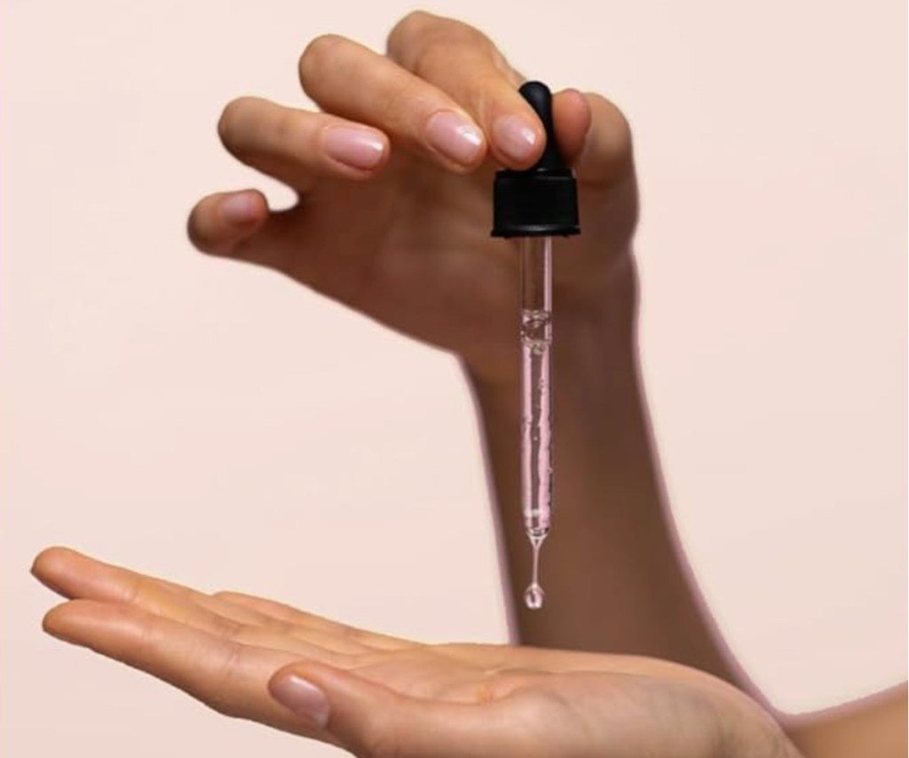 hand holding serum dropper