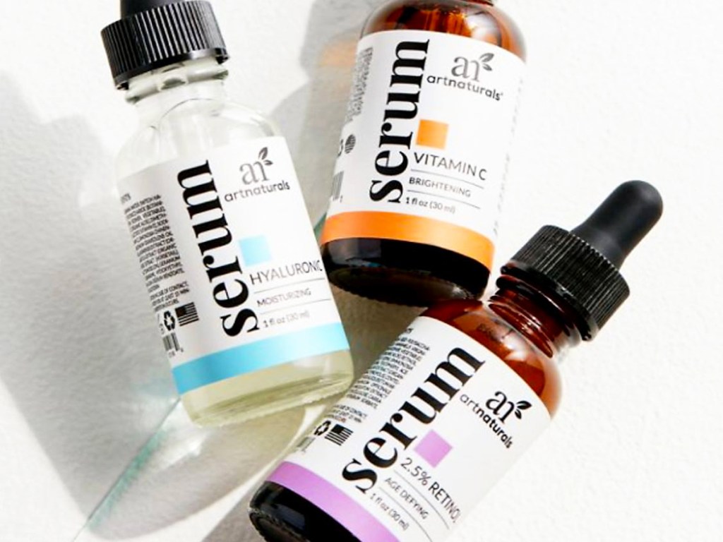 three bottles of Vitamin C, Retinol, and Hyaluronic Acid serums