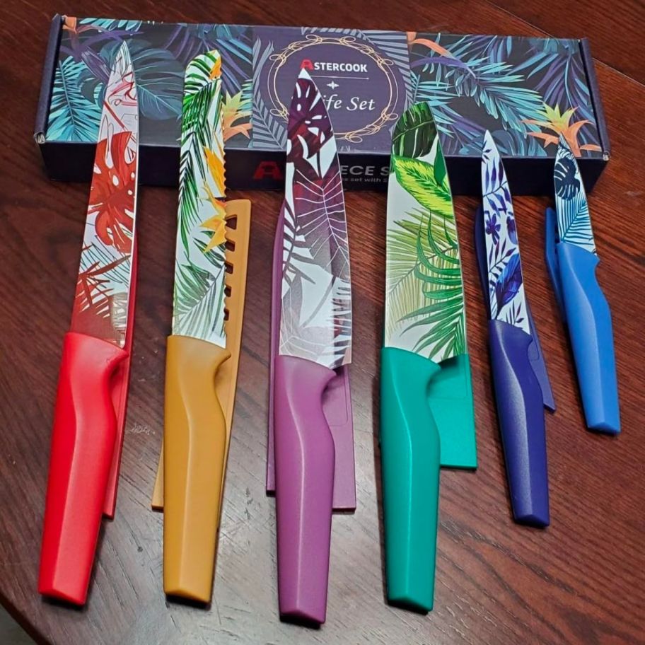6 kitchen knives with colorful tropical plant designs on the blades
