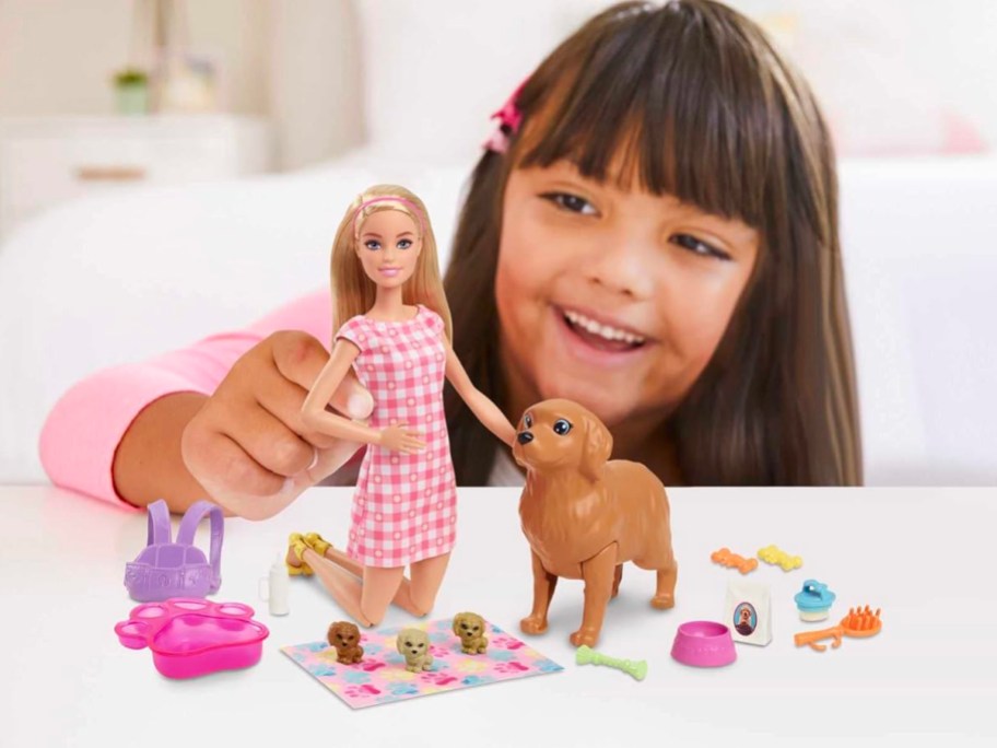 girl playing with barbie and dog playset