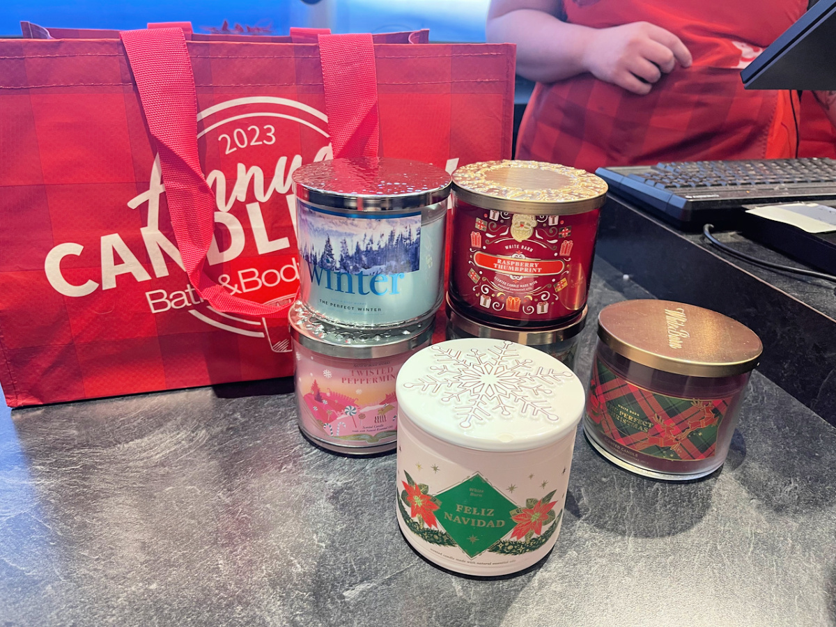 bath & body works candles and red bag at a register