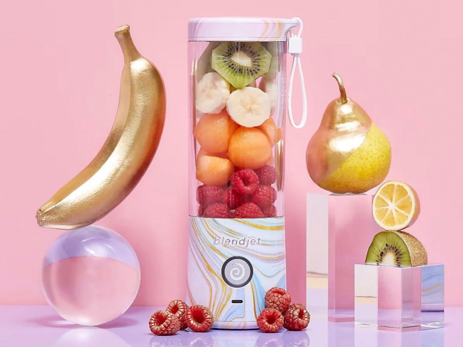 white marble blenderjet with fruit inside with pink background