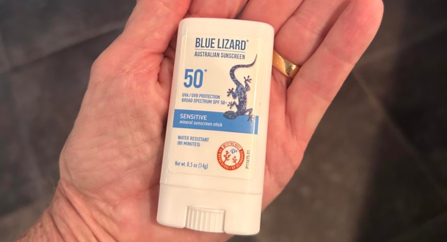 blue lizard sunscreen stick in persons hand