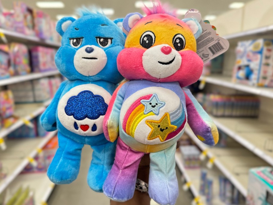 hand holding two carebears