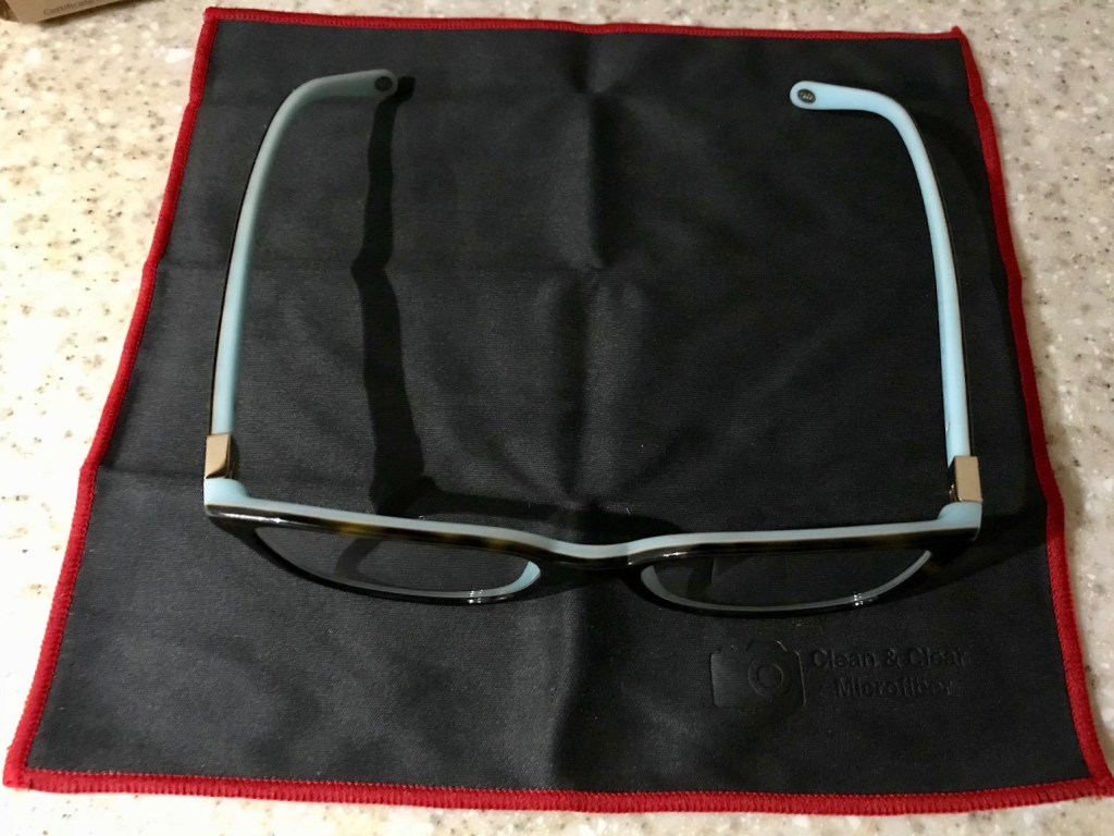 eyeglasses on black microfiber wipe