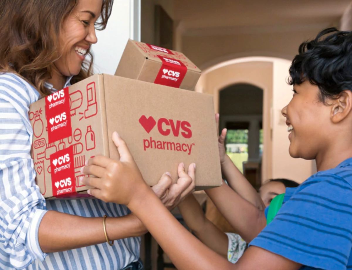 a kid handing a cvs box to a mom 