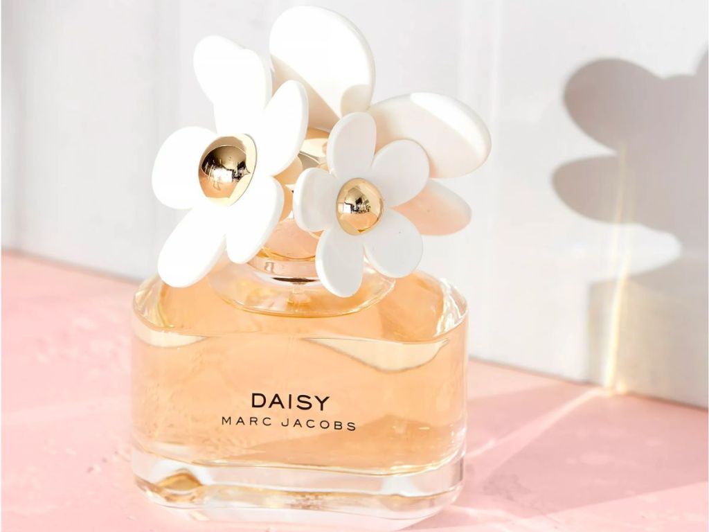 a small bottle of daisy by marc jacobs sitting on a table