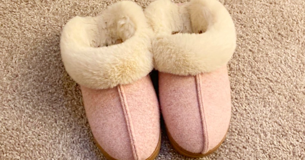 pink dearfoam slippers on carpet