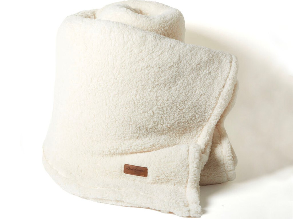 white sherpa blanket rolled up