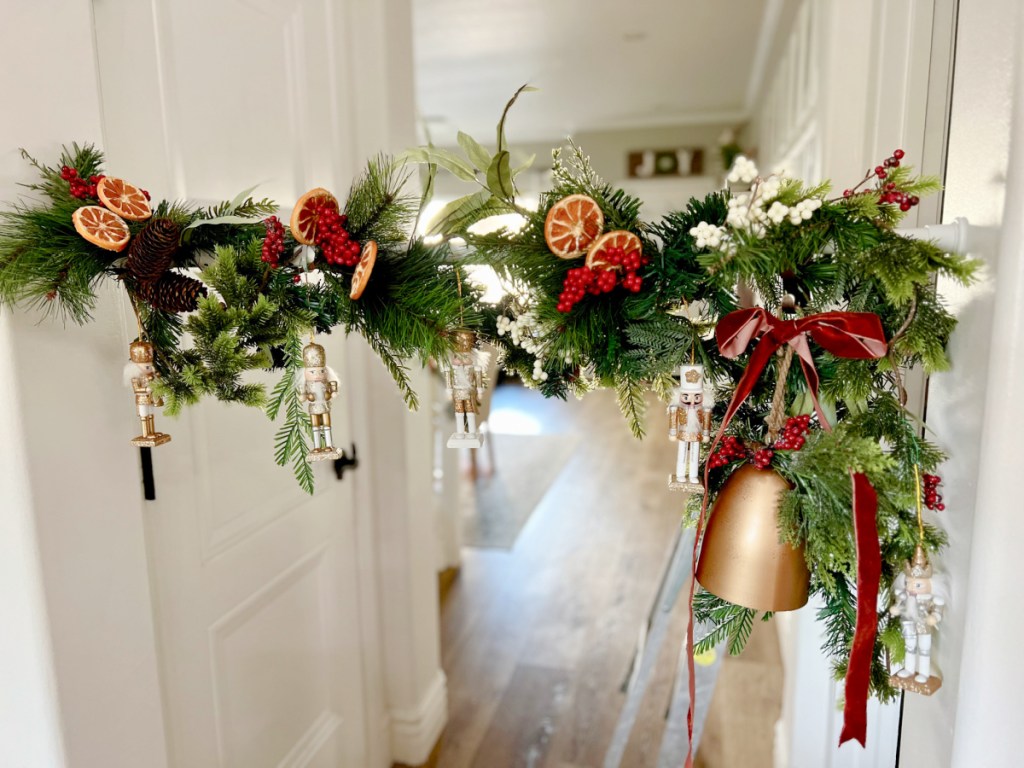decorating a tension rod with christmas garland