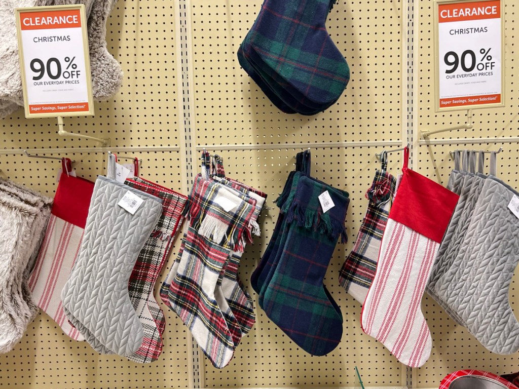 display of Christmas stockings with 90% off sign and different colors