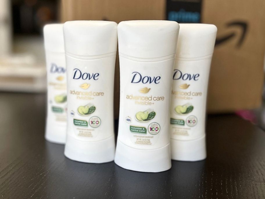 4 dove deodorants on black counter 