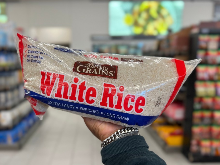 holding a bag of white rice